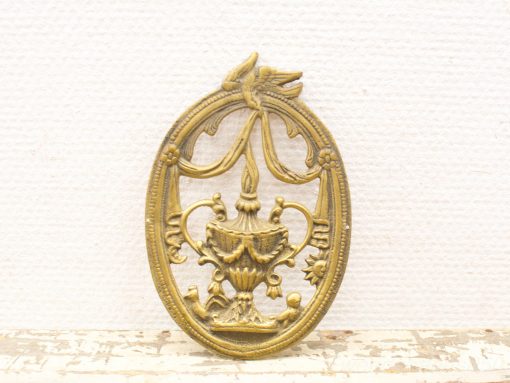 Elegant bronze decorative piece featuring a stylized urn and bird, perfect for vintage interiors.