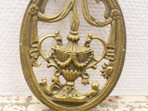 Vintage gold urn ornament with floral motifs, perfect for elegant home decor.
