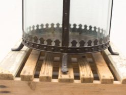 Elegant metal lantern on a rustic wooden pallet, perfect for indoor and outdoor decor.