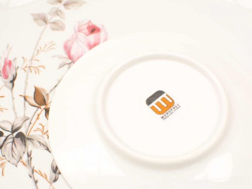 Elegant vintage porcelain flower plate by Monopoly, featuring delicate pink roses and green leaves.