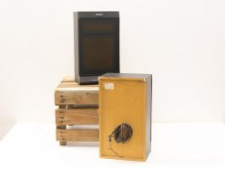 Vintage Philips monitor and box displayed on rustic wooden crate, showcasing retro technology charm.