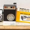 Vintage CIDEX light meter and POPULAR 606 flash unit for classic photography enthusiasts.