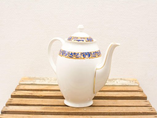 Elegant porcelain teapot with floral designs and gold accents, perfect for stylish tea moments.