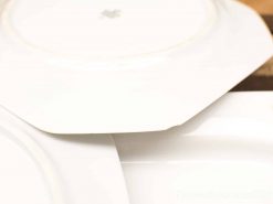 Elegant vintage white ceramic plates for stylish dining and beautiful table settings.