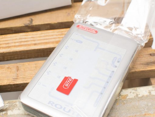 SITECOM router showcased on rustic wood, blending modern technology with natural aesthetics.