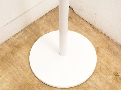 Sleek white stand for lamps and accessories enhances modern interior design with elegance.