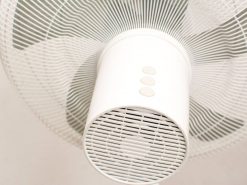 Modern white ceiling fan with sleek design and easy-to-use controls for efficient airflow.