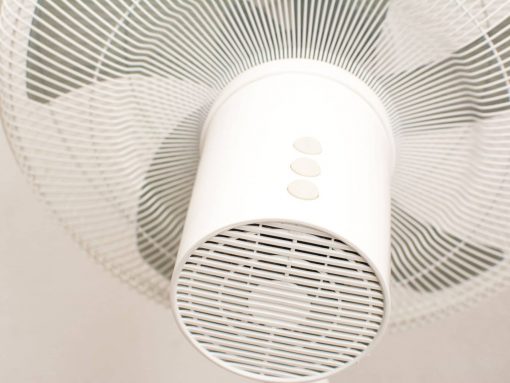 Modern white ceiling fan with sleek design and easy-to-use controls for efficient airflow.