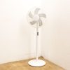 Modern minimal standing fan with translucent blades, perfect for contemporary interiors.