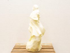 Unfinished female sculpture in motion, embodying elegance with flowing drapery and creamy tones.