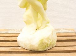 Elegant stone sculpture of intertwined women in a graceful dance, showcasing timeless beauty.