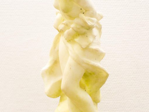 Elegant marble sculpture of a woman tenderly holding a child, symbolizing love and connection.