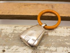 Elegant vintage keychain with silver finish and vibrant orange ring, perfect for keys.
