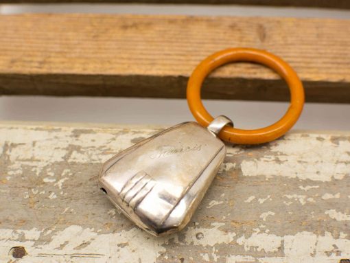 Elegant vintage keychain with silver finish and vibrant orange ring, perfect for keys.
