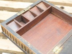 Elegant wooden organizer box with compartments, showcasing craftsmanship and timeless appeal.