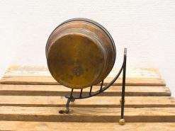 Vintage brass kettle on a sleek black stand, showcasing elegant craftsmanship and timeless charm.