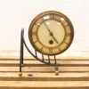 Elegant vintage brass desk clock with Roman numerals, perfect for stylish decor or workspace.