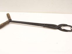 Vintage long-handled tongs with wooden grips and sturdy metal jaws for versatile use.