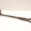Antique-style tongs with intricate metalwork and a wooden grip, perfect for functional and decorative use.