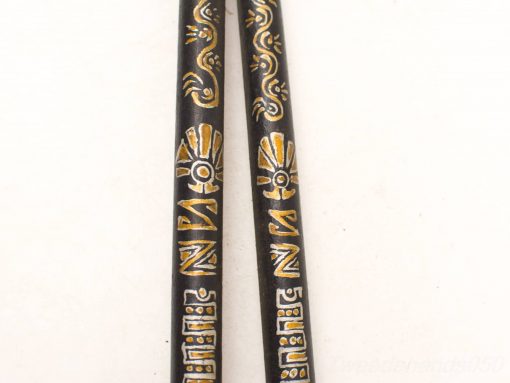 Elegant black vintage chopsticks with golden motifs, perfect for dining or decorative display.
