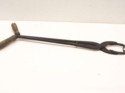 Vintage long-handled tongs with wooden grips and sturdy metal jaws for versatile use.