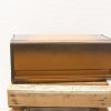 Elegant brown metal storage container with lift-top lid, perfect for organizing in any room.