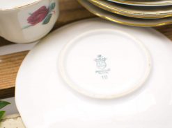 Elegant vintage porcelain dinnerware set with gold trim and floral design, perfect for special occasions.
