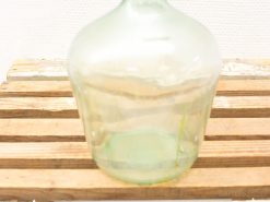 Elegant green glass bottle on rustic wood, perfect for home decor and collection.