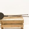 Antique metal tongs on rustic wooden pallet, perfect for vintage cooking enthusiasts.