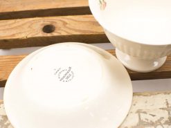 Elegant vintage porcelain bowls on rustic wood, perfect for collectors and special occasions.