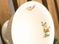 Elegant vintage porcelain bowl with delicate floral patterns in soft hues, perfect for decor.