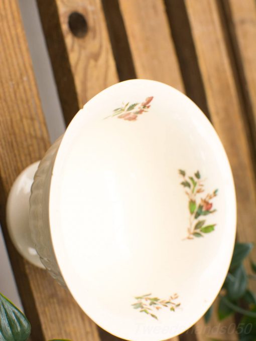 Elegant vintage porcelain bowl with delicate floral patterns in soft hues, perfect for decor.