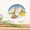 Serene ceramic plate featuring a sailing boat amidst a tranquil landscape and windmill.