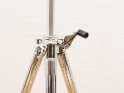Sleek, polished metal tripod for photography and videography with sturdy, adjustable legs.