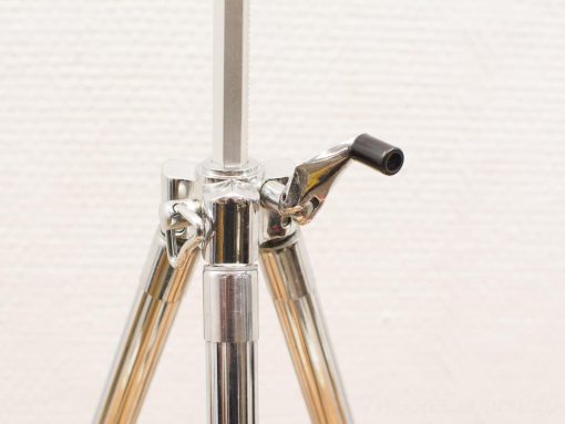 Sleek, polished metal tripod for photography and videography with sturdy, adjustable legs.