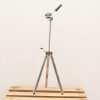 Sleek chrome tripod with adjustable tension arm for professional photography and videography support.