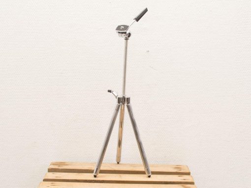 Sleek chrome tripod with adjustable tension arm for professional photography and videography support.