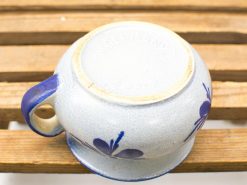 Charming blue ceramic pot with floral design, perfect for any decor style.