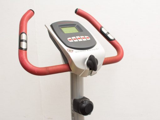 Stylish indoor exercise bike with red handlebars and digital display for efficient workouts at home.