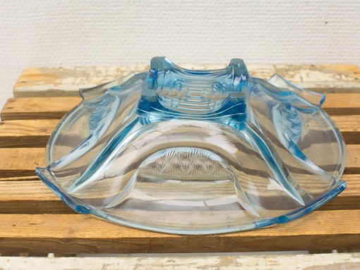 Elegant blue glass candle holder with wavy edges, perfect for enhancing ambiance and style.
