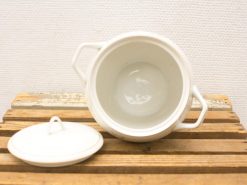 Elegant white ceramic casserole with lid, perfect for serving in any dining setting.