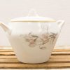 Elegant porcelain teapot with hand-painted floral design and gold trim, perfect for tea gatherings.