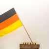 German flag with wooden support, ideal for vintage displays and showcasing national pride.