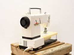 Vintage Duplomatic 9041 sewing machine on a wooden pallet, perfect for creative projects.