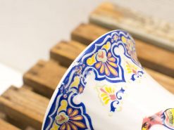 Vintage ceramic vase with colorful floral design, perfect for adding elegance to your decor.
