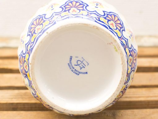 Beautiful hand-painted Italian ceramic bowl with vibrant floral designs and glossy white interior.