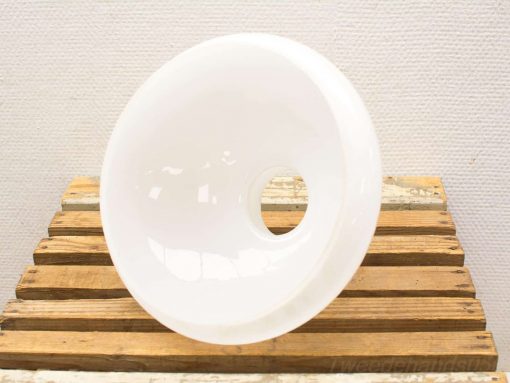 Elegant white funnel bowl on rustic wood, showcasing simplicity and refined design.