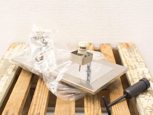 Vintage hardware components for installation, featuring metal base and accessories for enthusiasts.