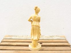 Elegant ivory female sculpture showcasing graceful drapery and intricate detailing. Perfect for art collectors.