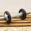 Chrome dumbbell with rubber weights for effective strength training and workouts.
